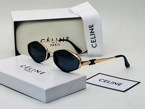 نظارة بإطار ذهبي وعدسات داكنة