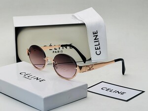 نظارة بإطار ذهبي وعدسات داكنة